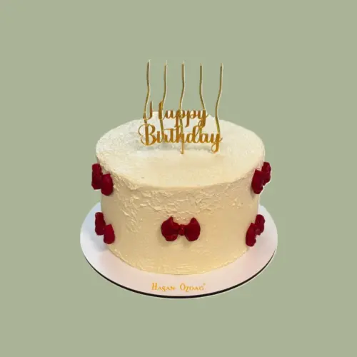 Birthday cake with red bows and gold candles